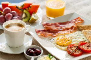 bountiful breakfast of eggs bacon and fruit